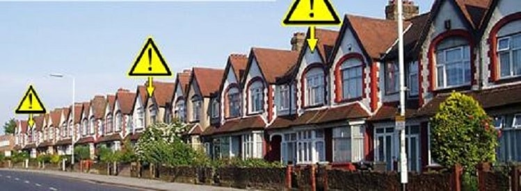 Row of houses with warning signs