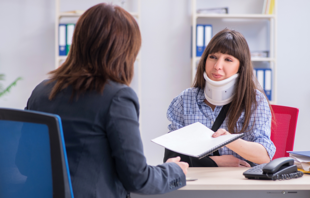 An injured employee consulting with a personal injury lawyer for advice on insurance claims. New Orleans, Louisana