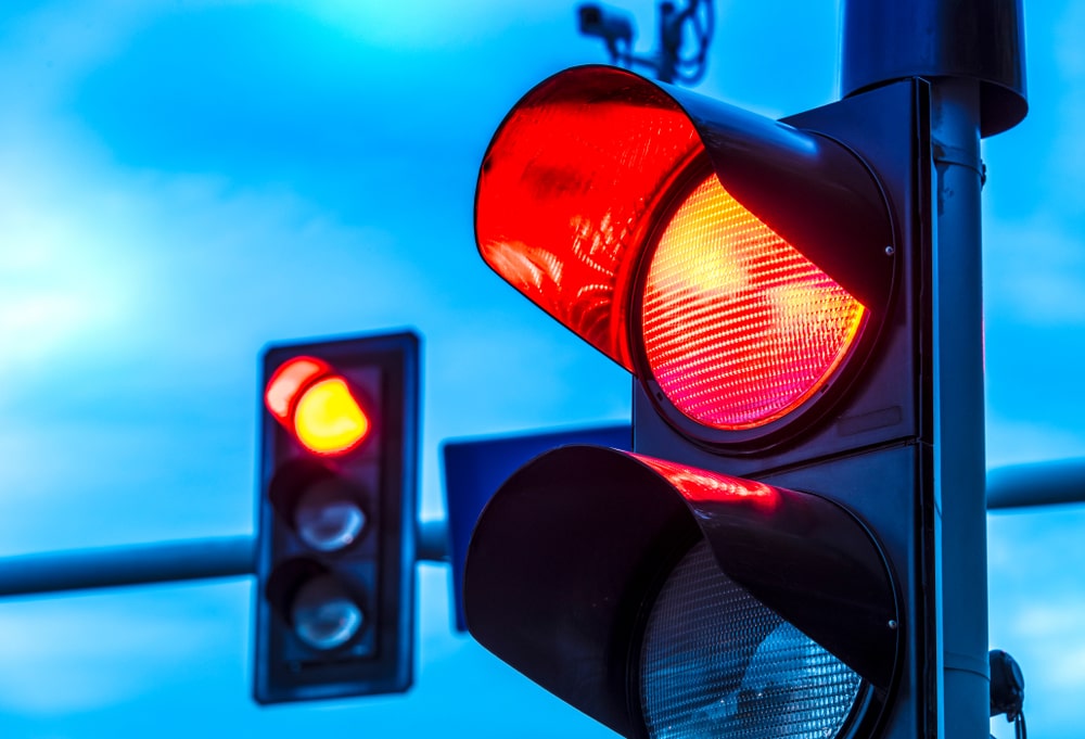 Traffic lights displaying a red light over an urban intersection, a common site for T-bone collisions in New Orleans