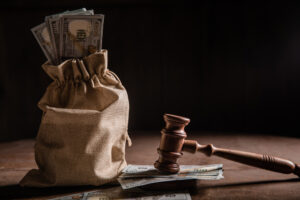 Dollar money bag and judge's gavel. Concept of attorney fees. personal injury lawyer new orleans