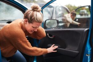 Female Motorist In Crash For Crash Insurance Fraud Getting Out Of Car - personal injury attorney new orleans